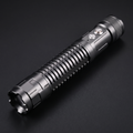 High-power tactical laser torch with ribbed aluminium body on a dark background
